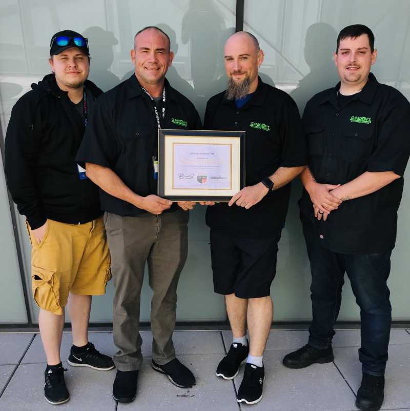 the team at gordon 's appliance holding a top pro certificate